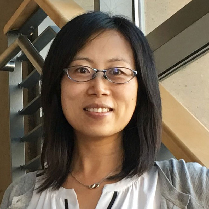 Headshot of Professor Yu. A woman with medium, ear-length hair with dark eyes.